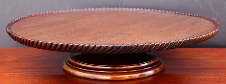 A handsome English lazy susan of mahogany, for the table - featuring a revolving round 23