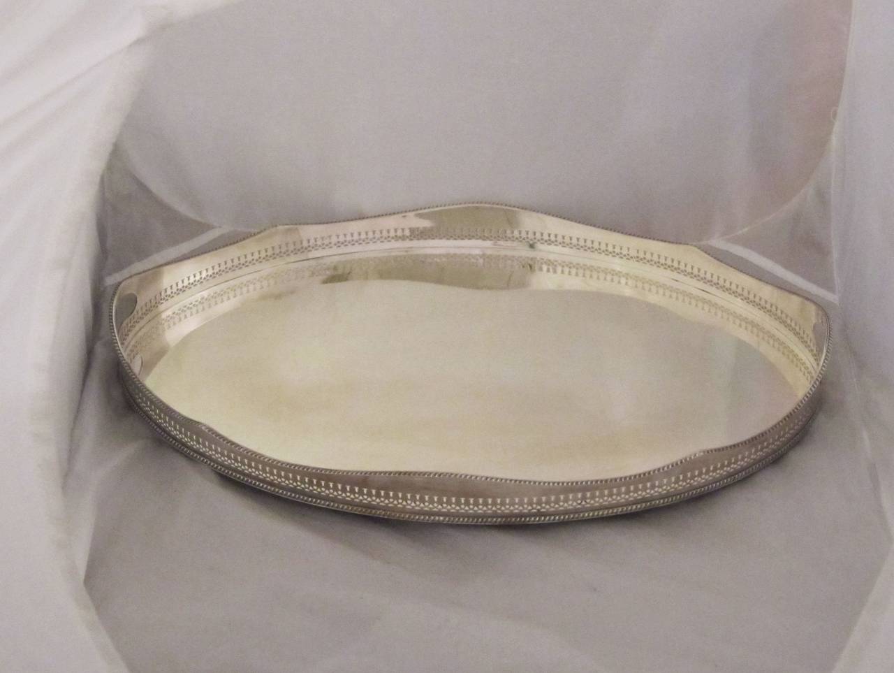 A handsome English oval gallery serving tray with pierced serpentine gallery around the circumference.

We have similar gallery trays in a variety of styles and sizes - Please enquire