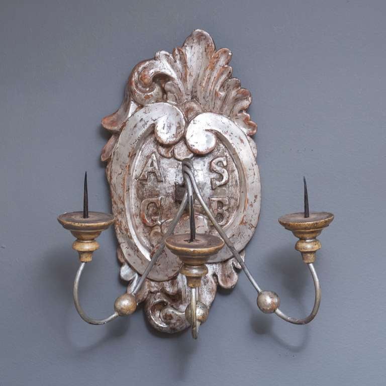 A pair of early 19th century Italian silver gilt wall sconces (or wall lights) with three arms for candles and featuring a design of initials to each wall mount:

A S.
G B.

Priced as a pair: $3995 the pair