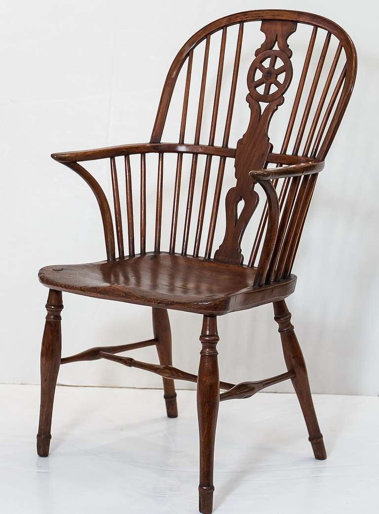 A handsome early English Windsor chair featuring a bowed top rail and pierced splat back, with solid seat on turned stretcher. With a ship captain's wheel motif to the split.