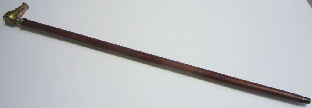An American sea captain's walking cane or stick of mahogany, capped with a working retractable, four-draw nautical telescope (or spyglass) of brass and optical glass, mounted as a handle - a mariner's treasure!

Canes of this design were also