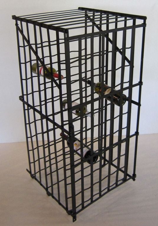 A French wine cage or wine locker of steel featuring fitted slots for wine bottle storage and a hinged door with locking clasp for securing the contents.

With storage slots for up to 100 bottles.