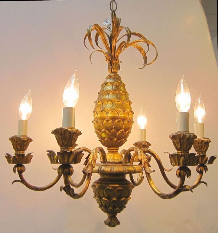 A French gilt hanging light fixture or chandelier, featuring six serpentine arms emanating from a center design of a pineapple above a downward facing finial  -  A symbol of hospitality!

23