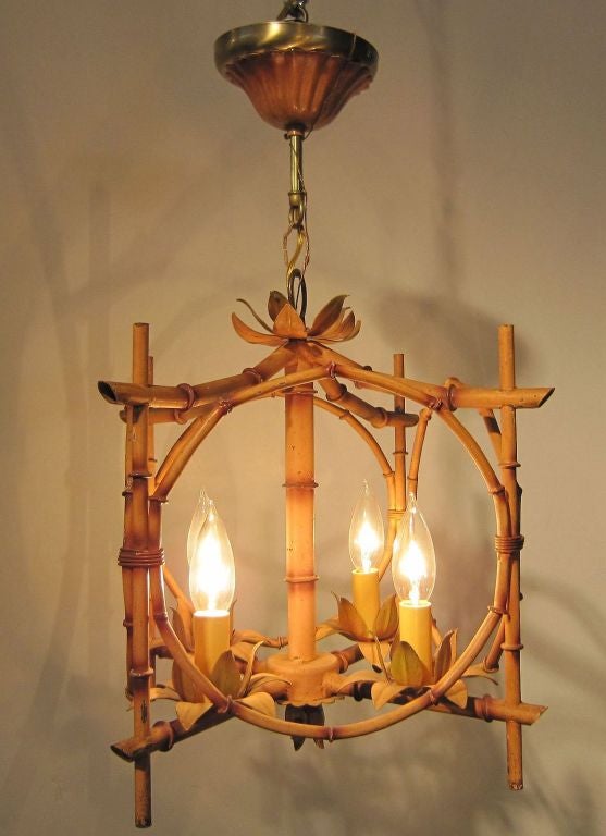 A bamboo hanging four-light fixture or chandelier featuring a frame of four opposing circles mounted to a square pagoda frame.