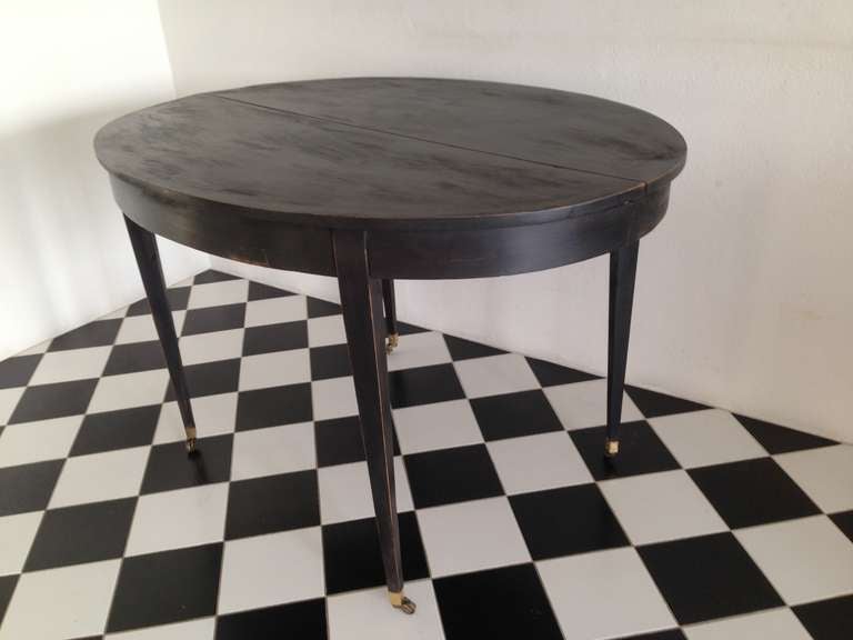 A black painted dining table made in Sweden 1790-1810. Paint added later but in a manner according to the Gustavian period. 2 leaves ( 23.6 in each).