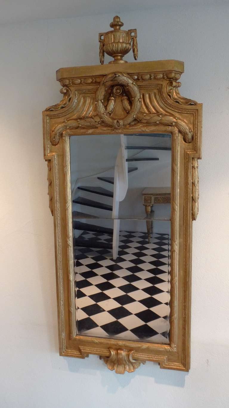 Giltwood mirror made in the transition between the high Gustavian and Late Gustavian period, 1780. The mirror is not signed but attributed to the greatest mirror maker in Sweden during the Gustavian Period (1751-1799). A very similar mirror was made