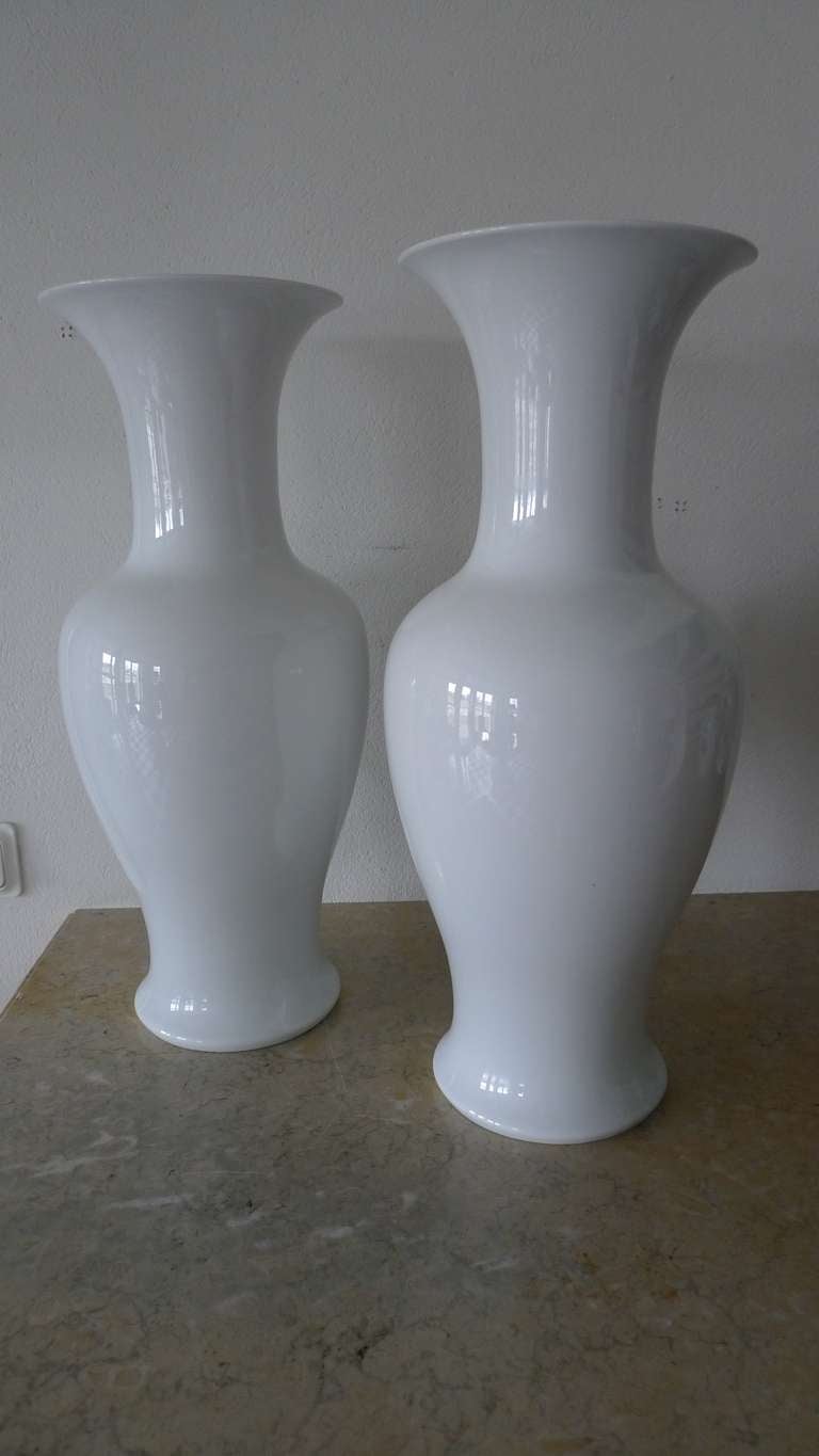 Pair of tall white urns in a baluster shape. Made during the 20th Century in Germany. Signed Kaiser.