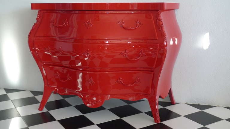 A chest of drawers lacquered in red. Original hardware. Red base can be included. 