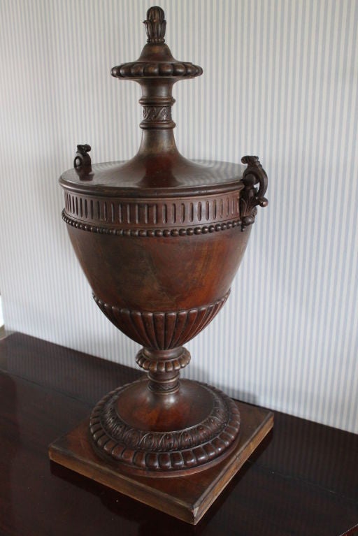 Urn Neoclassical Mahogany 18th Century France. Significant attributes for the neoclassical period such as pearl beading and channels. Standing on a square base.