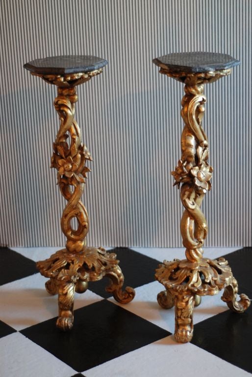 A Pair of Southern European Gilt wood Gueridons with gray marble tops.
