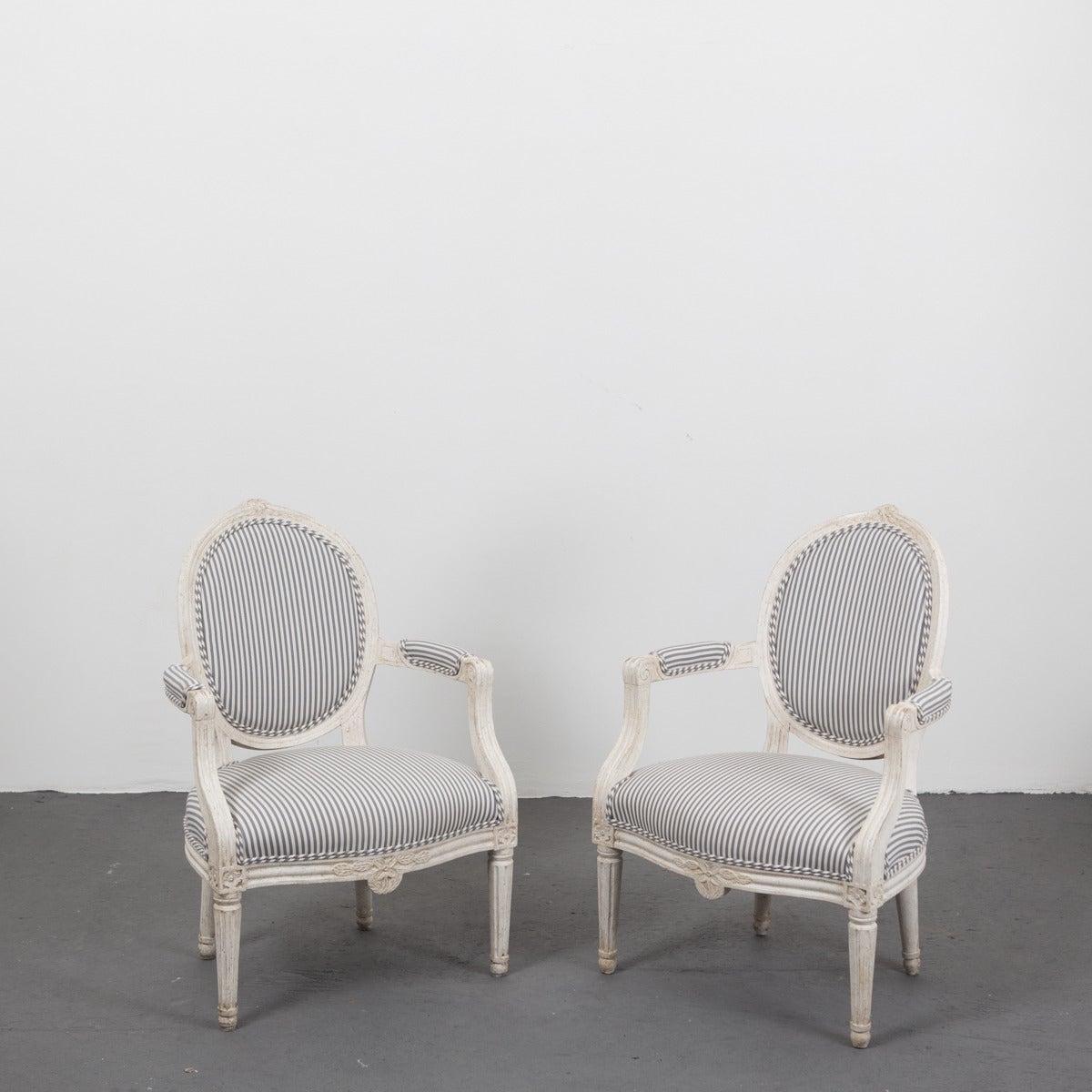 Armchairs pair of Swedish Gustavian 18th century, Sweden. A pair of Swedish Gustavian armchairs from the early part of the Gustavian period. Upholstered medallion shaped back splat and a shield shaped seat. Frieze with carved flowers matching the