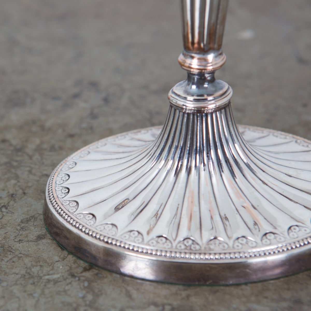 A pair of silver plated candlesticks made in England during the 19th Century.