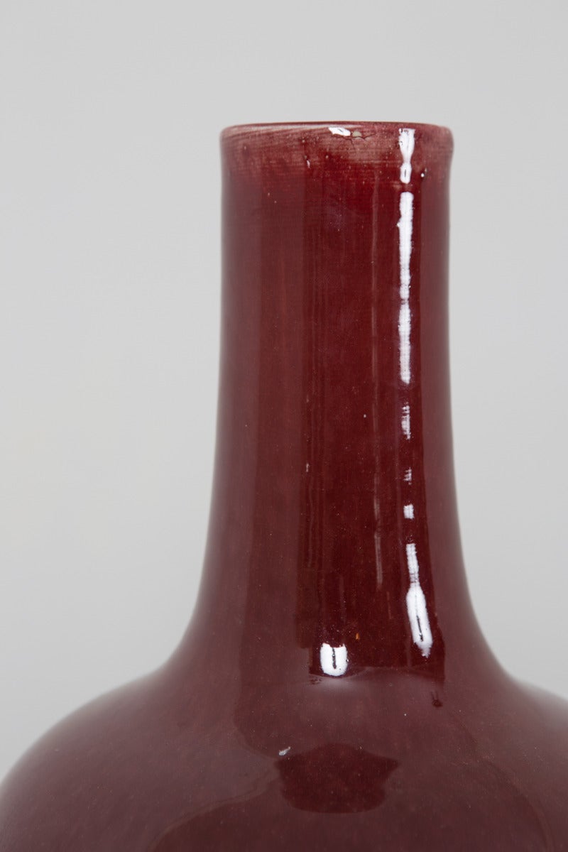 A Chinese vase in oxblood colored glazed pottery made 1900. Small hair line cracks underneath - see in picture