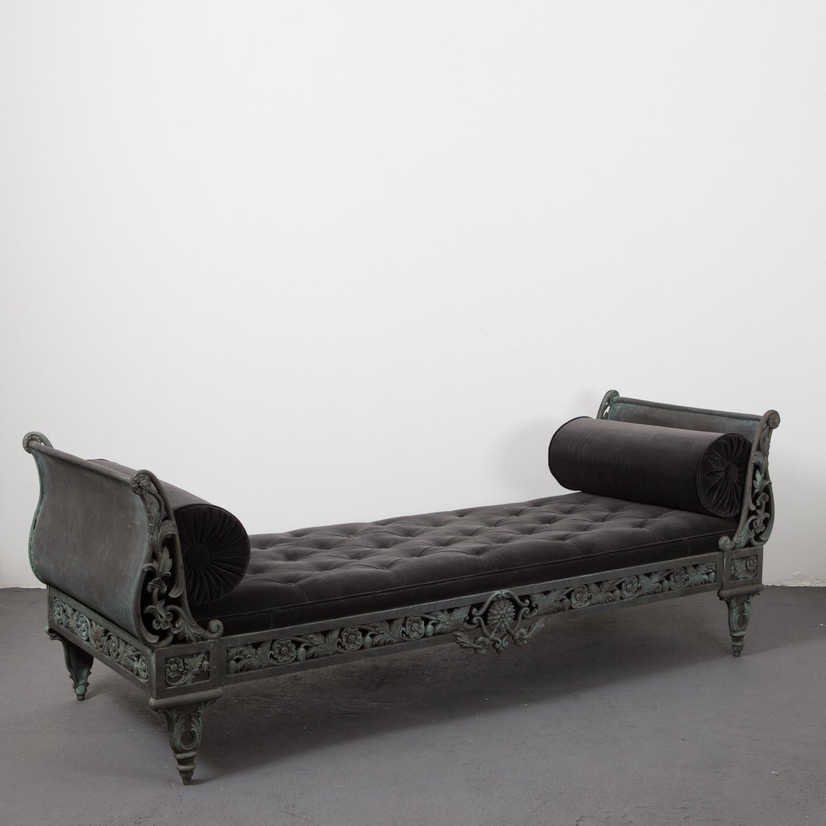 Daybed French 20th Century Cast Iron France. A cast iron daybed in a oxidized green color. All in cast iron with cushion and bolster in dark gray velvet. Frame decorated with flowers and leaves, would go perfectly on a porch or in a garden. Made