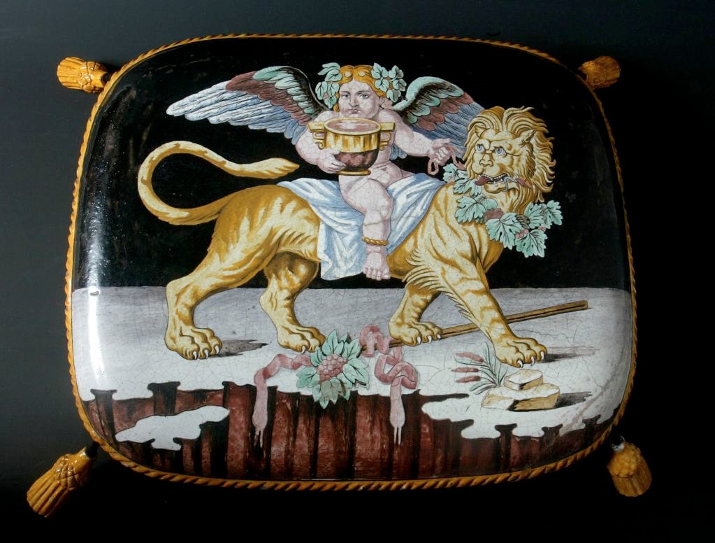 Pillow Porcelain French 19th Century Black Yellow Napoleon France. Porcelain pillow with four porcelain tassels made to rest on a stool. Pictured on the pillow is Napoleon as riding on a lion (which symbolized strength) drinking from a victory cup