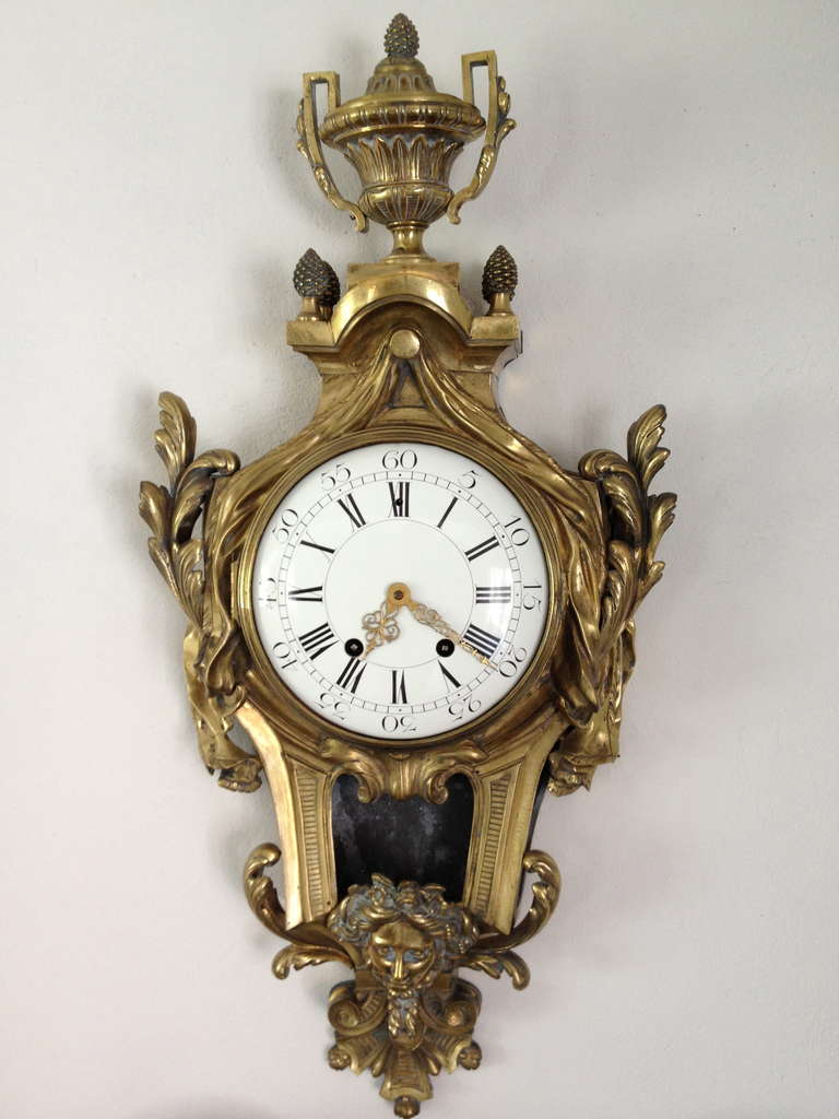 A beautiful Empire wall clock in solid bronze with delicate and well balanced details. Made during the 19th Century. Face in white enamel. In working condition.