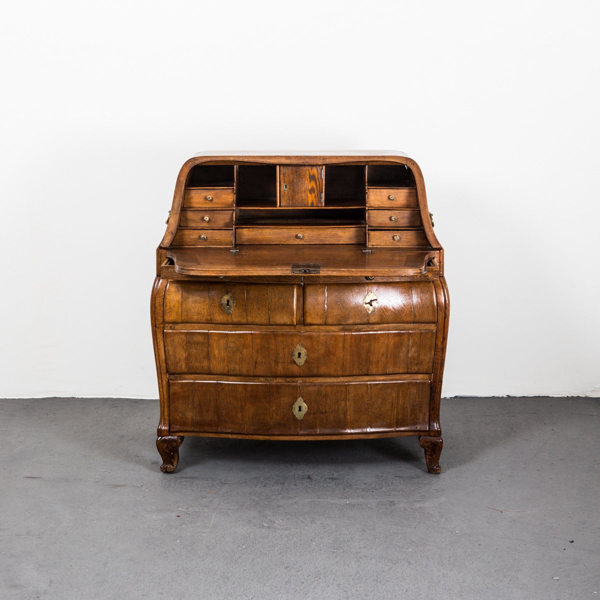 A secretary made in oak during the Rococo period 1750-1775 in Sweden. Original hardware in brass. Interior with compartments and drawers. Beautifully made in its original finish and lovely patina. 

Open desk surface is 14.5