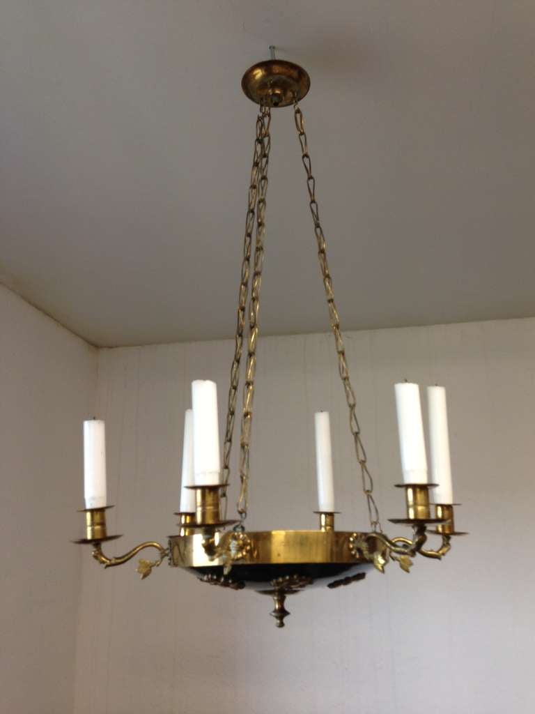 A Swedish Karl Johan chandelier in polished and blackened brass. Six arms with candle holders with flower details. Bowl with flat brass flowers. 