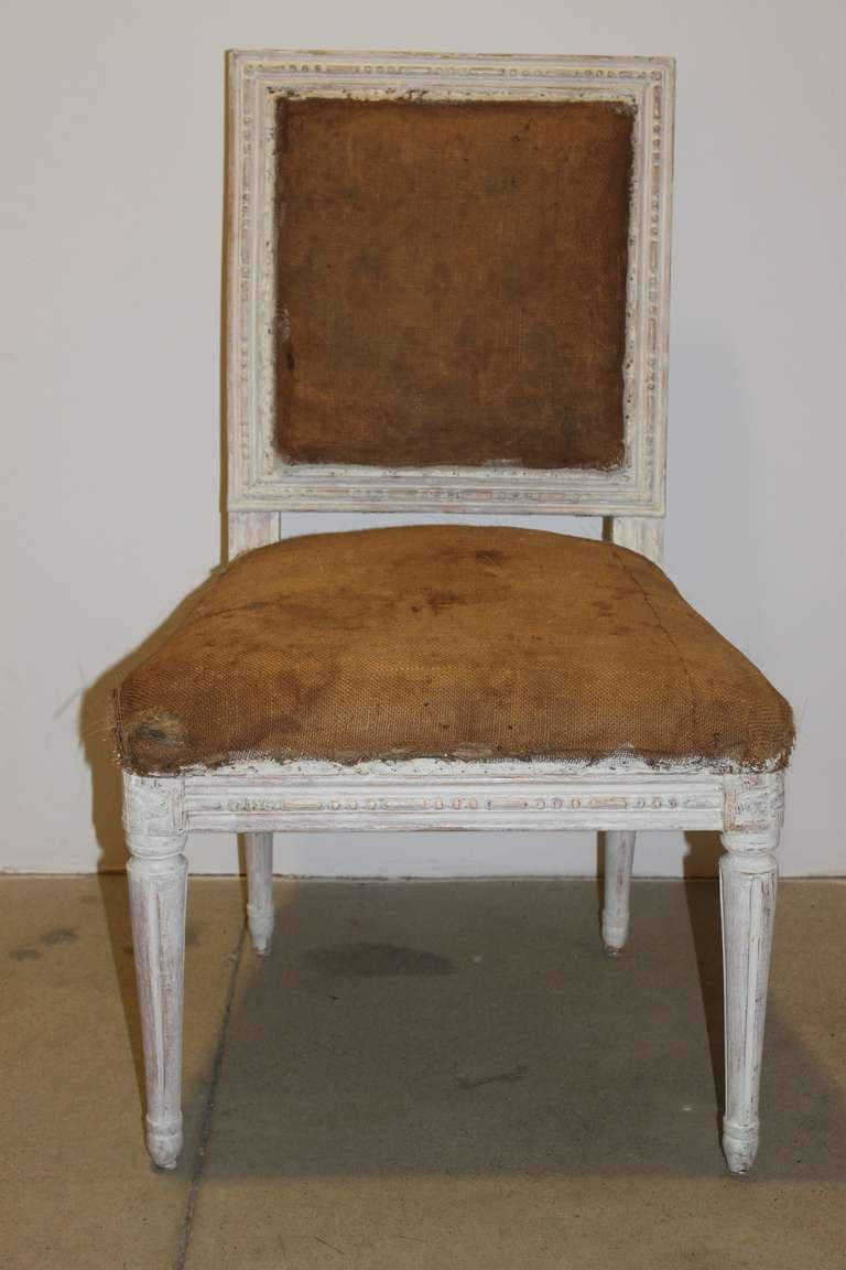 A pair of Swedish Gustavian side chairs in jute fabric. Rectangular backs and generous seat. Rounded corners with corner flowers and rounded channeled legs. 