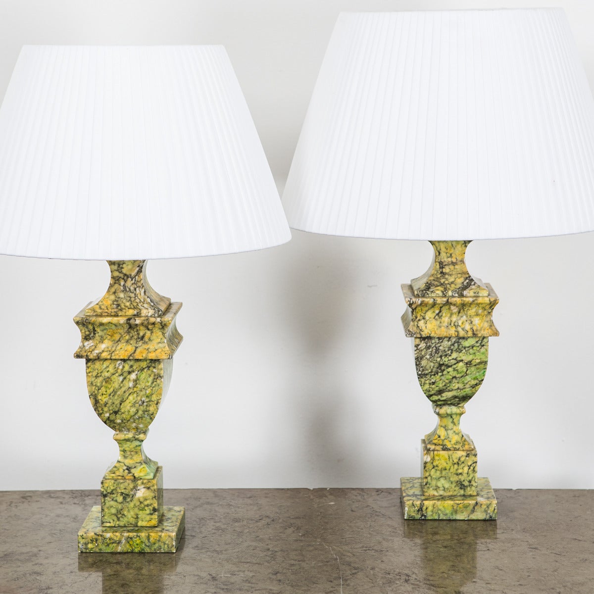 A pair of vibrant table lamps in a green and black marble base. Made circa 1950.