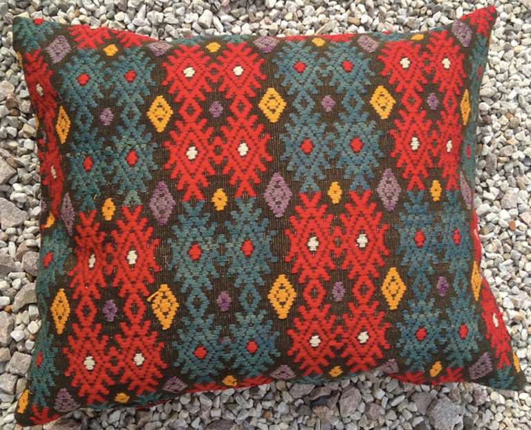A Pair of Pillows Made from Swedish 19th century Fabric. Embroidered with green, red and dark yellow on a moss green background.
