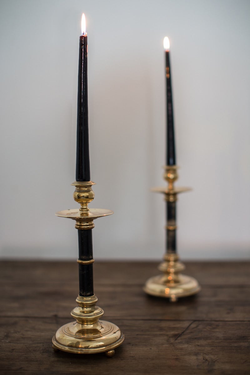 A pair of candlesticks in brass and black-stained wood. Made by Skultuna. Skultuna is Sweden's oldest industry and has an early 17th century brassworks, Skultuna Messingsbruk. 19th Century.