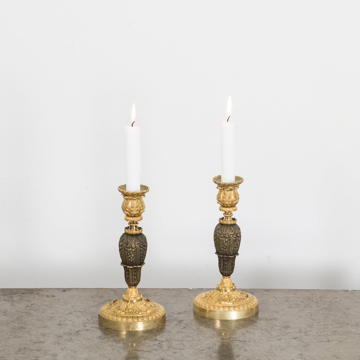 A pair of candlesticks made early 20th Century. Bronze and dark patinated bronze.