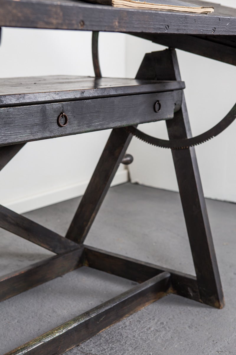 A really cool industrial architecture's sketching table in black painted wood and metal. Adjustable height form 25.5 to 33 in. Drawer for storage.