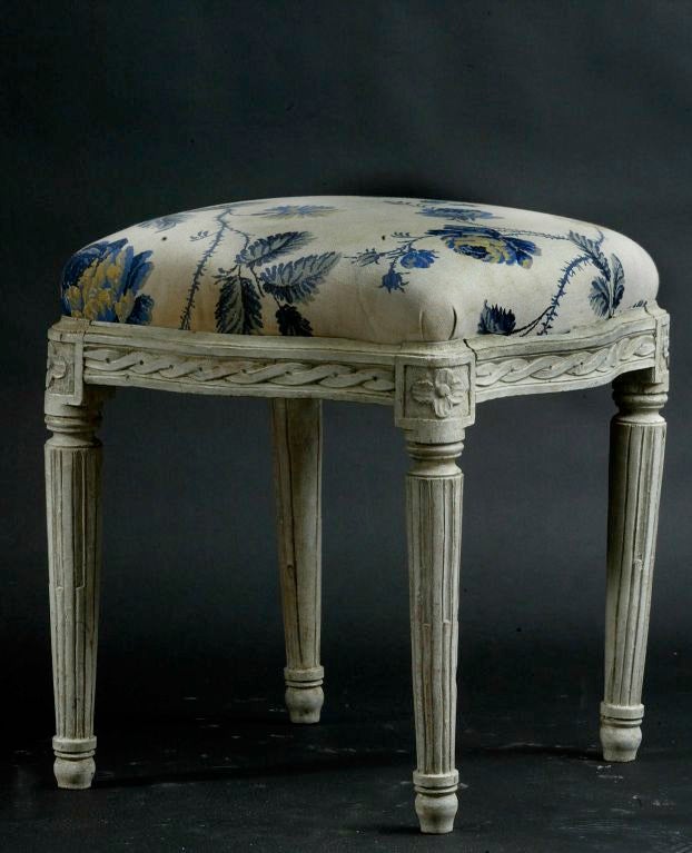 Stool Swedish Gustavian, 19th century, Sweden. A stool made in Sweden during the 19th century. Frieze decorated with a carved braid. Legs fluted with semi filled channels with a pear-shaped ending. Each corner has a carved flower.