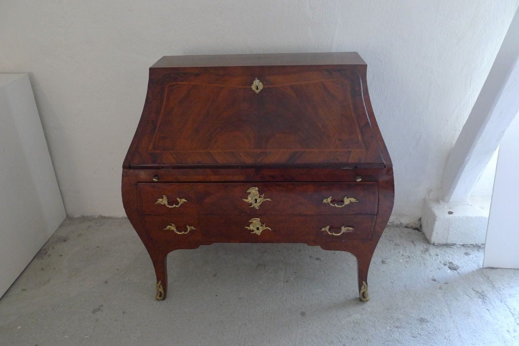 A very rare Swedish Rococo secretary in ALL original condition. Made in the typical Rococo shape in walnut, walnut root and citrus tree. The exquisite hardware are made in gilded bronze and has the shapes of shells and volutes. The curved legs has