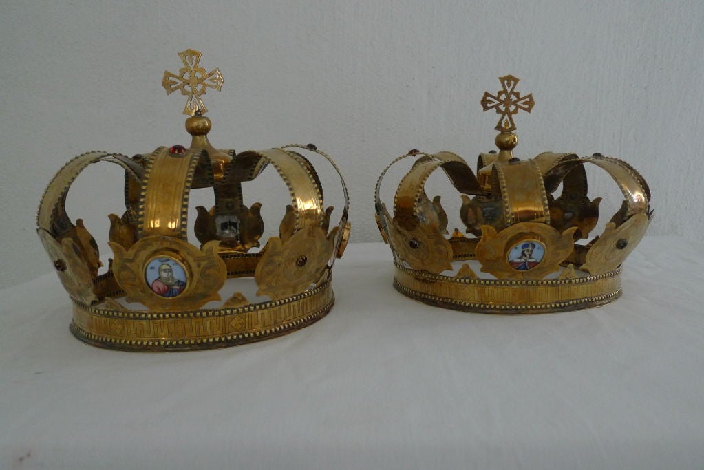 A pair of VERY unusual crowns made in Russia during the 19th Century and used during Greek Orthodox wedding ceremonies. The are entirely made in brass with inlayed with painted porcelain pictures of priests, decorated all over with rubies and