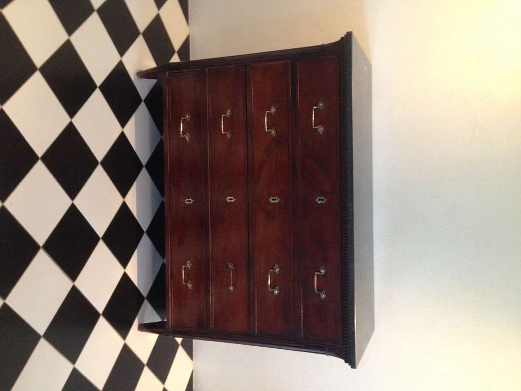 Stunning mahogany chest of drawers made during the late Gustavian period 1790-1810. Top made of gray lime stone. Hardware of brass.  Top drawer to be open as a writing desk. Channeled and rounded corners.