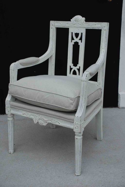 Armchair Swedish Gustavian White 19th Century Sweden. A beautiful armchair made during the Gustavian period. Back splat with a carved in a typical carving for chairs made in western part of Sweden. Upholstered seat with loose cushion.