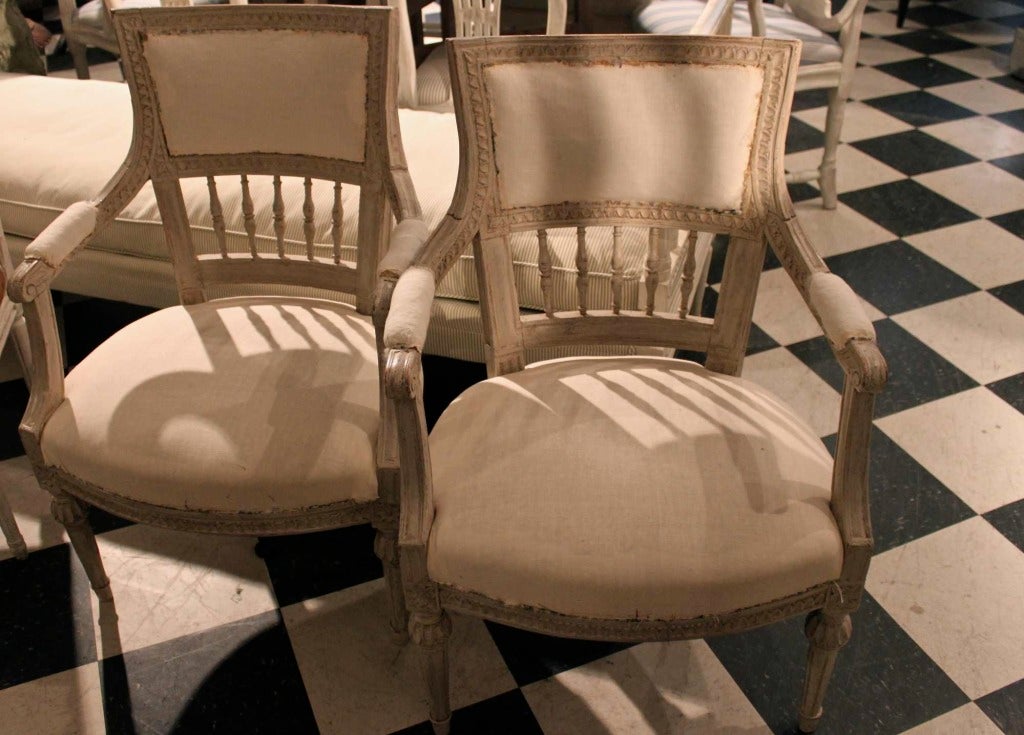 Armchairs Pair Swedish White Gustavian 1790-1810 Sweden. A pair of Gustavian armchairs in white paint. Leaf tip carvings and beautifully curved backs raised on spindles. Very sturdy and comfortable to sit in.