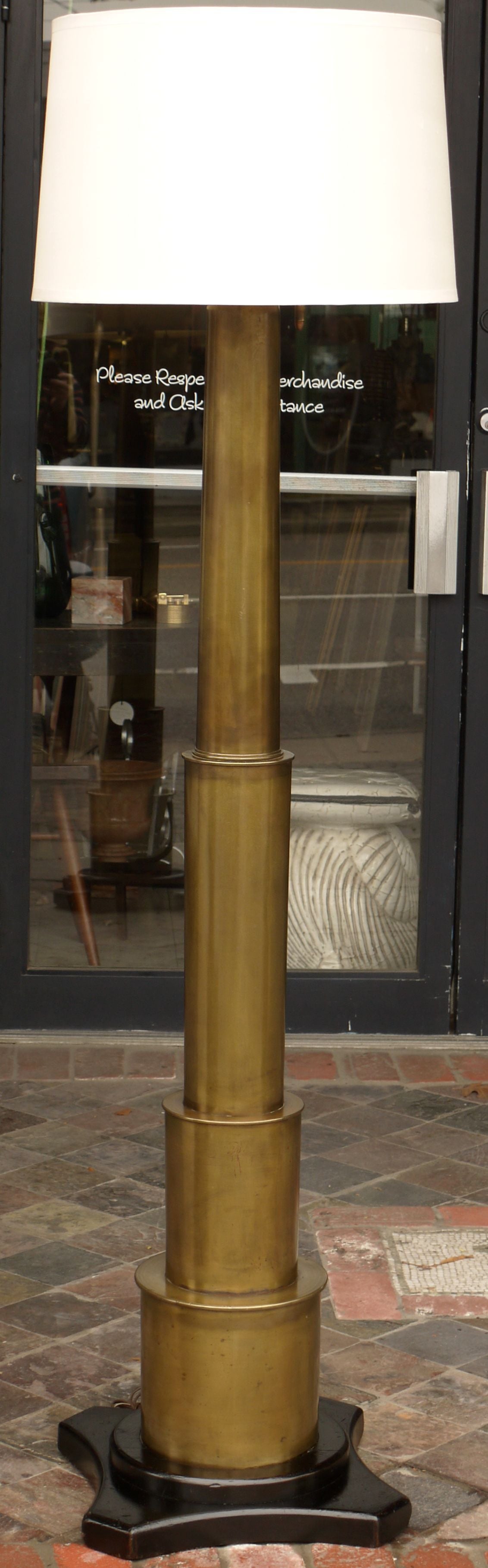 Stunning 1920s proto machine age floor lamp constructed from massive WWI artillery shells machined and stacked on top of each other. Top shell has been machined to allow sockets to come out of tip and the top unscrews and acts as the finial to the