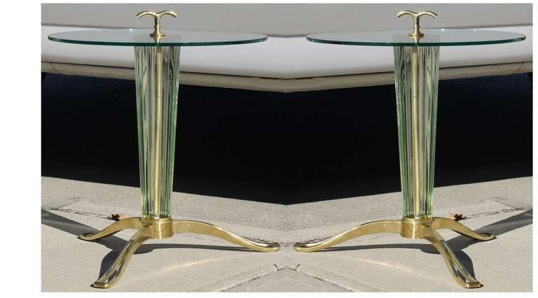 Gorgeous pair of celery colored murano glass and polished brass tables with stunning pierced feet and expressive handle which mimics the curve to the foot.   The glass has a wonderful optical look due to the reeded glass and tends to catch the