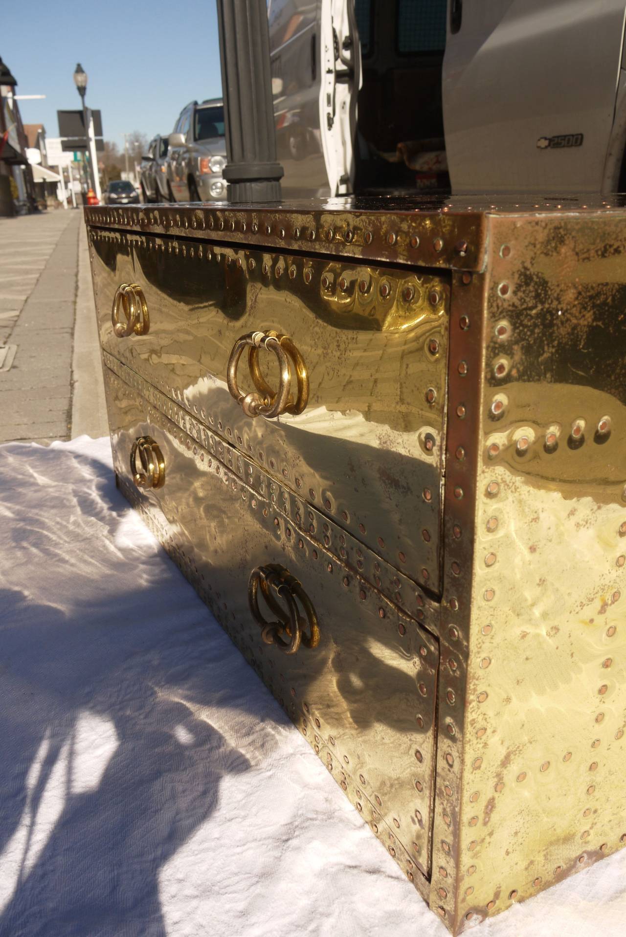 Pair of studded brass chest by Sarreid Ltd. of Spain. Work well as nightstands, end and coffee tables under windows or at the end of the bed. Finished back.