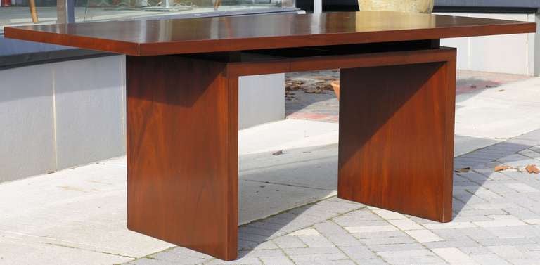 Wonderful solid mahogany chunky floating top desk with gorgeous dovetails on the side.  Top is made out of two wide boards which have been perfectly grain matched so it seems like a solid giant single board top.  Inlaid brass detail with removable
