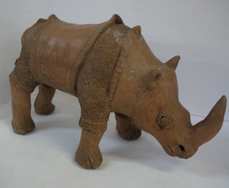 Large vintage Studio pottery rhino from the 1950's, great texture and patina on the rhino.  All constructed hollow but still heavy, weight and texture seems like the material they make bricks out of.  Heavy and aged looking. 