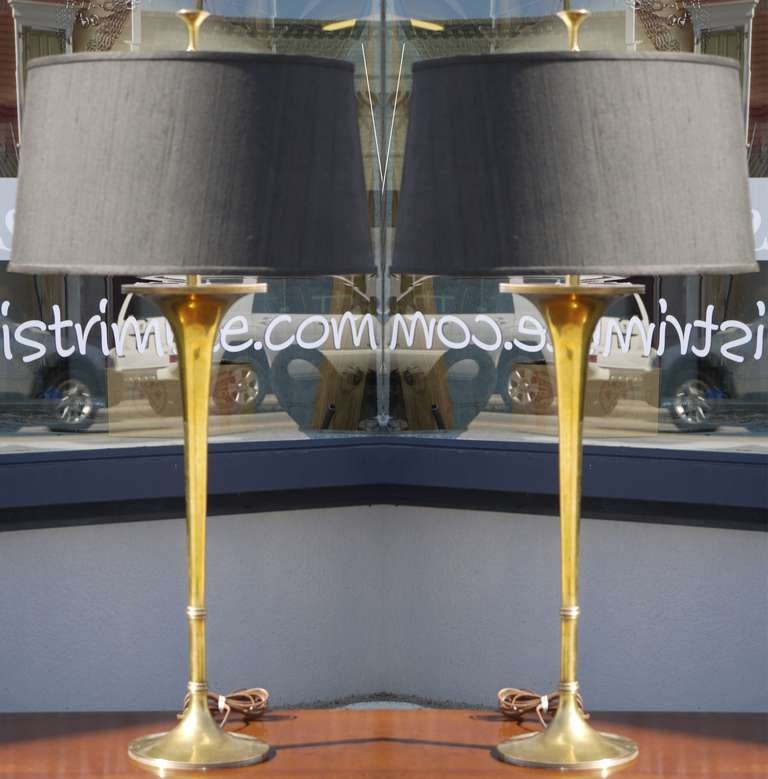 Sculptural pair of solid brass trumpet lamps by Chapman in 1986.  Shade isn't included but we can give you the shade size if interested.