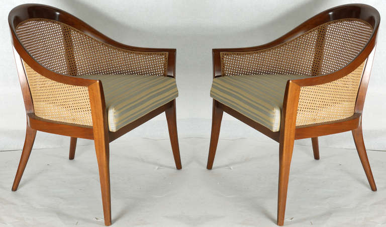 Handsome pair of Harvey Probber Lounge Chairs in natural mahogany finish featuring a caned barrel back and svelte characteristics.  