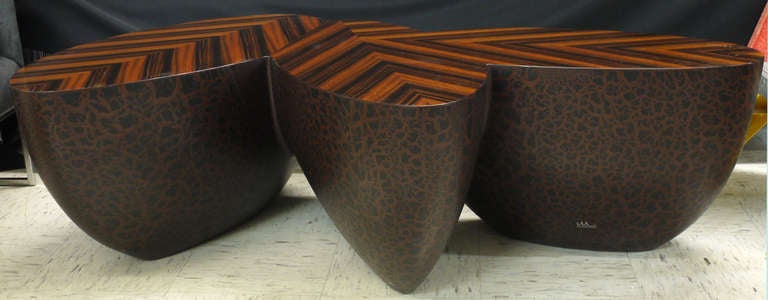 The Sizzle cocktail table is as much sculpture as it is designer furniture. The unique three-way, book-matched veneer modern table top is made only of the highest quality materials by Wendell Castle's top craftspeople. 