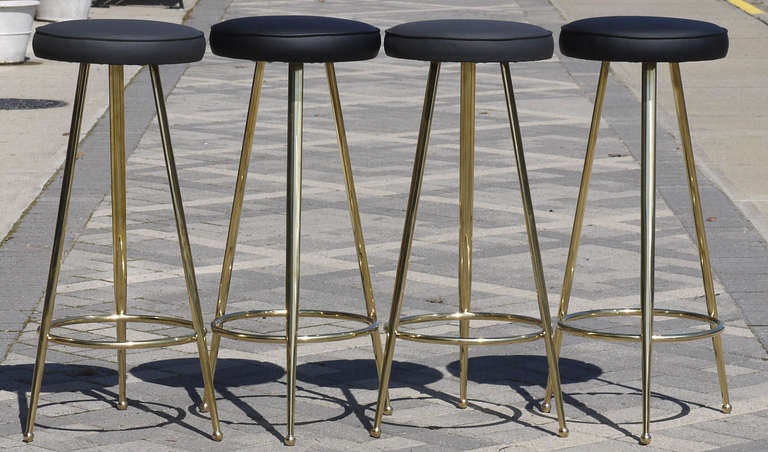 Stunning set of four Italian barstools polished to a high luster.  Seats upholstered with alternating colors of charcoal and black vinyl.  Seat measures 13.25