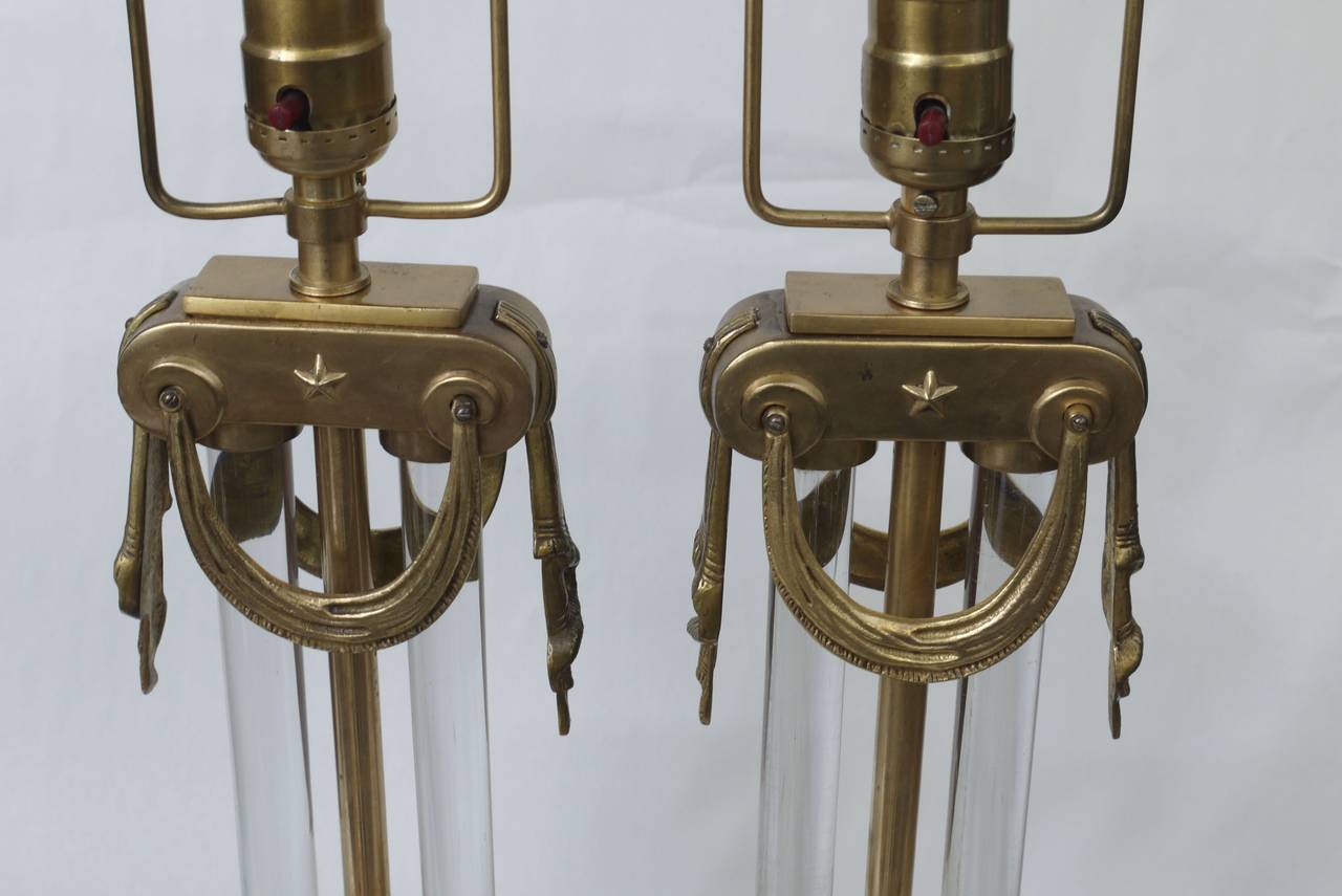 Stunning pair of heavy brass lamps by Mutual Sunset with glass columns built into the lamp. Produced in the 1930s these are a stunning example of Art Deco design.
