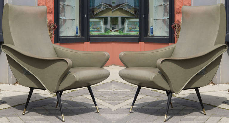 A wonderful pair of 1950's Italian sculptural chairs with spectacular lines.  While being really stylish they are also extremely comfortable which is a rare mix.   