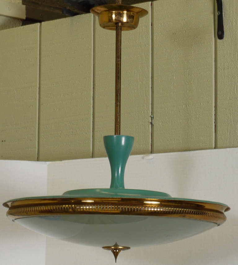 A luxurious Italian light fixture featuring a wonderful vintage teal enameled  metal and brass housing a frosted glass diffuser for light.  Brass and metal has a wonderful patina.  Rewired for american use with three candelabra sockets.