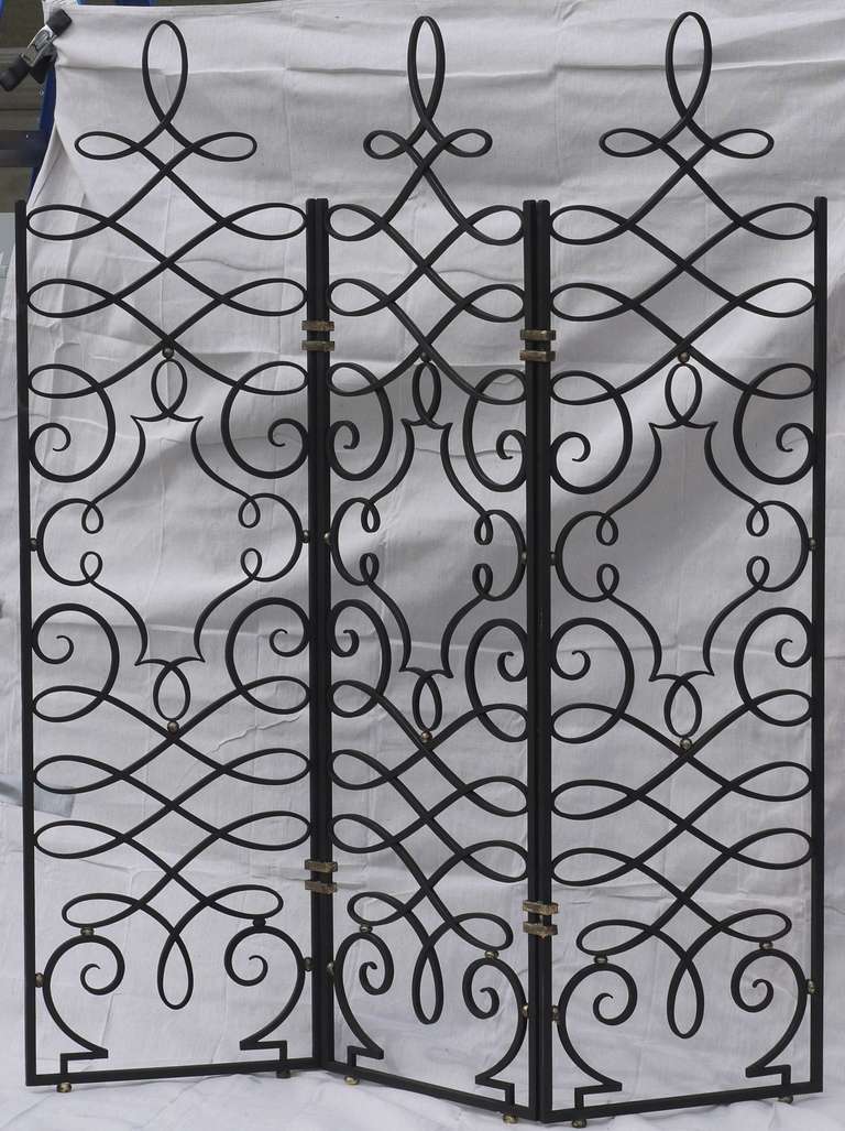 A wonderful hand forged screen by Gilbert Poillerat featuring some of the best metalwork I've ever seen.  The tapers on the lines are impeccable, and the weight of the line changes gently through the curves.  As you can see in the photos whenever
