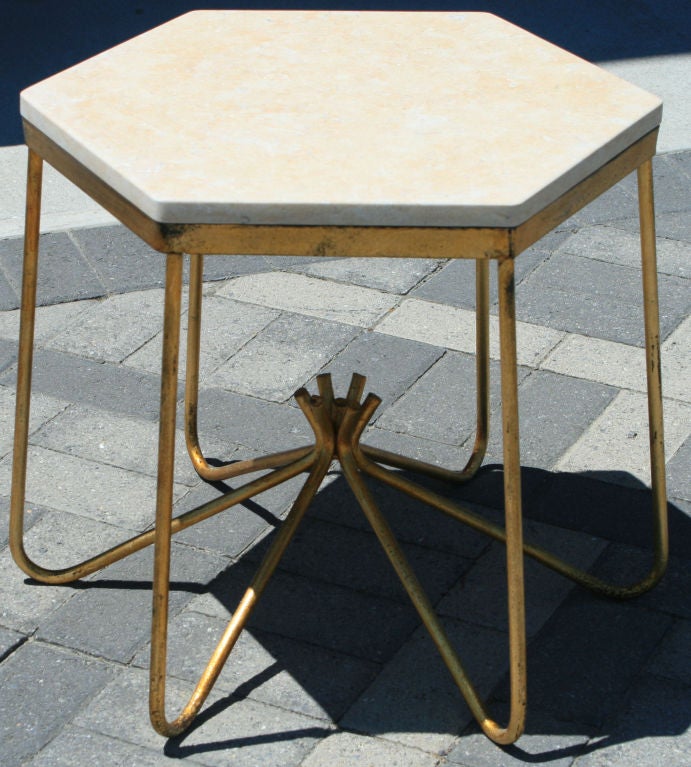 A published gilt occasional table attributed to Jean Royere, done in the 1940s, with a peachy rose travertine top. The table isn't in the royere book but was sold through Tajan Auction 11-24-2003 lot number 145 in their 20th Century Decorative Arts