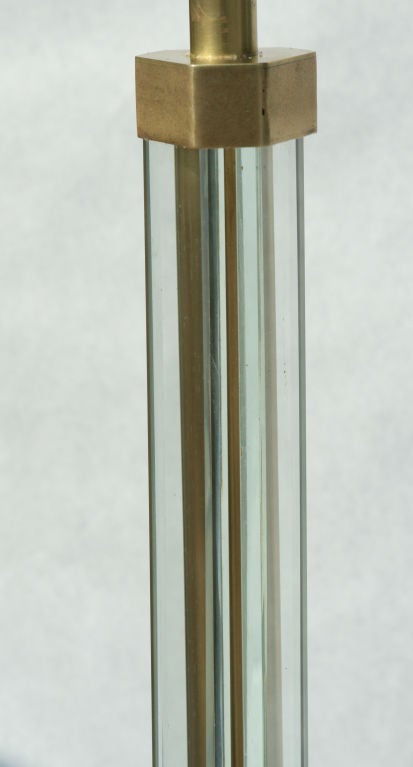 Gorgeous beveled glass floor lamp consisting of three panels of glass surrounding a central core of brass, supported by 3 graceful bronze legs in the style of Fontana Arte.