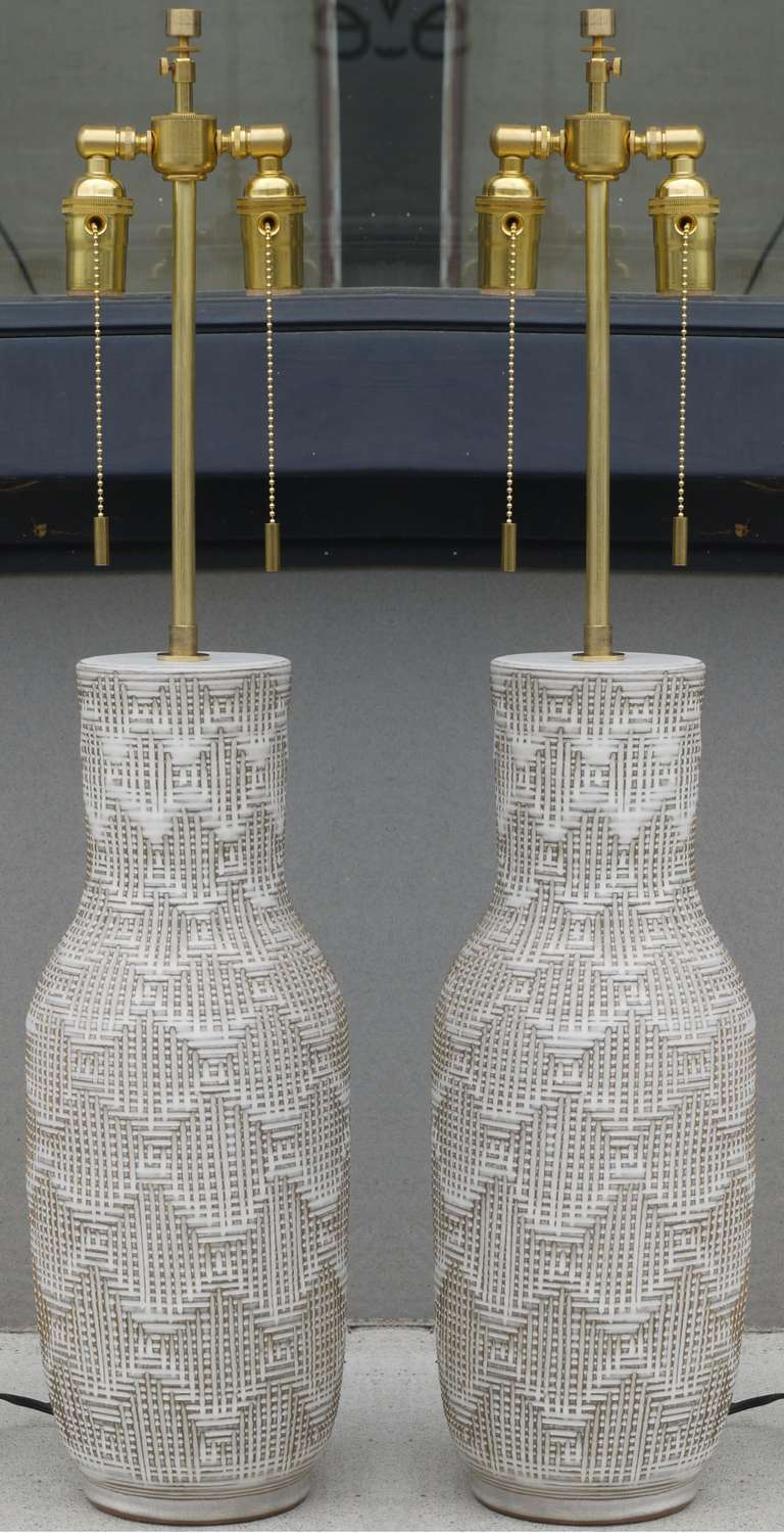 Stunning early Pair of Lamps by Design Technics with an incised basketweave design.   These lamps are from the early 1960s, and all the sockets and hardware has been updated.